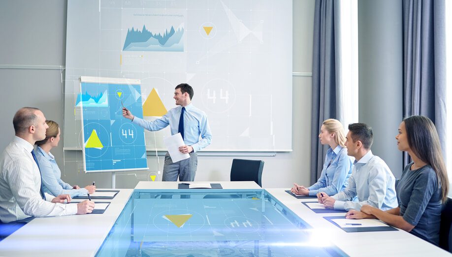 a group of people sitting around a conference table.