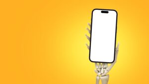 A 3D-rendered skeleton hand holds up a smartphone with a blank white screen against a bright yellow background, highlighting the risks to your online reputation in today’s digital world.
