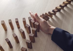a person is playing with wooden blocks on a table.