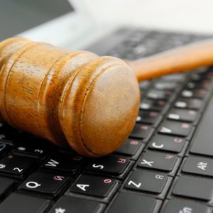 A gavel rests on a computer keyboard.