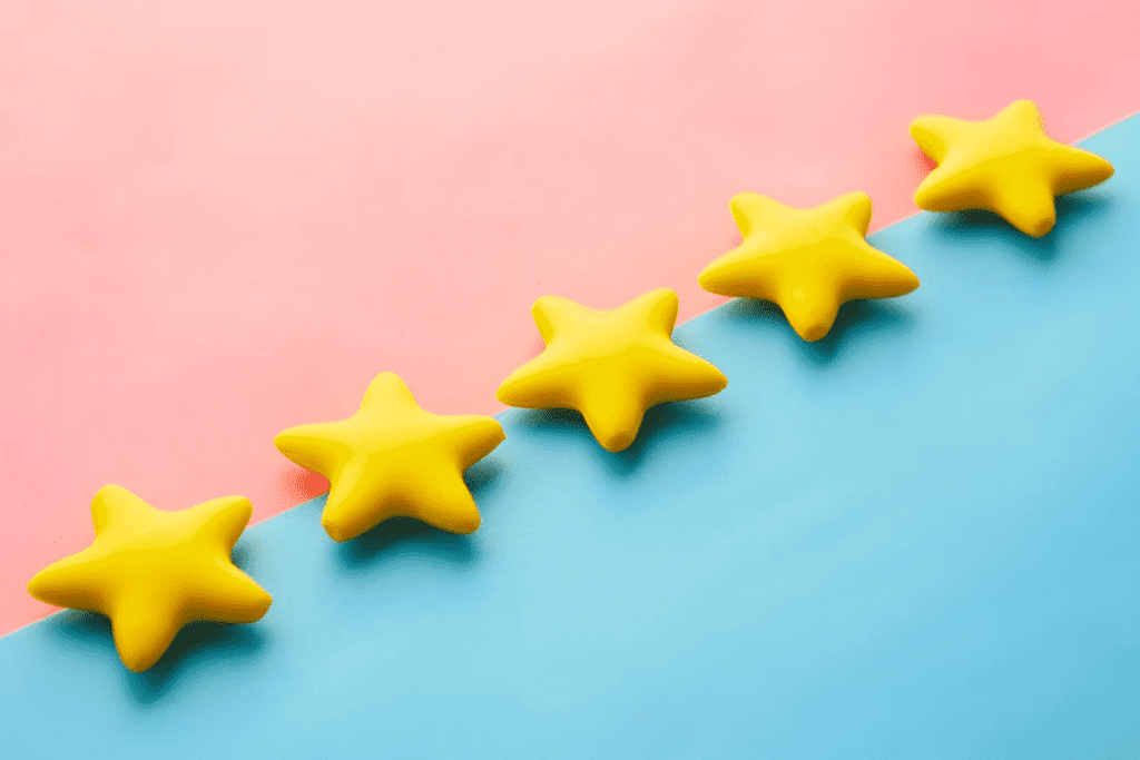 a row of yellow stars sitting on top of a blue and pink surface.