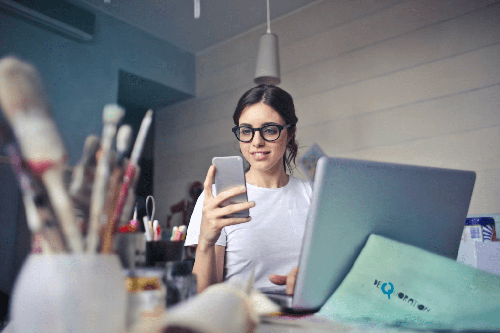 a woman sitting in front of a laptop computer.