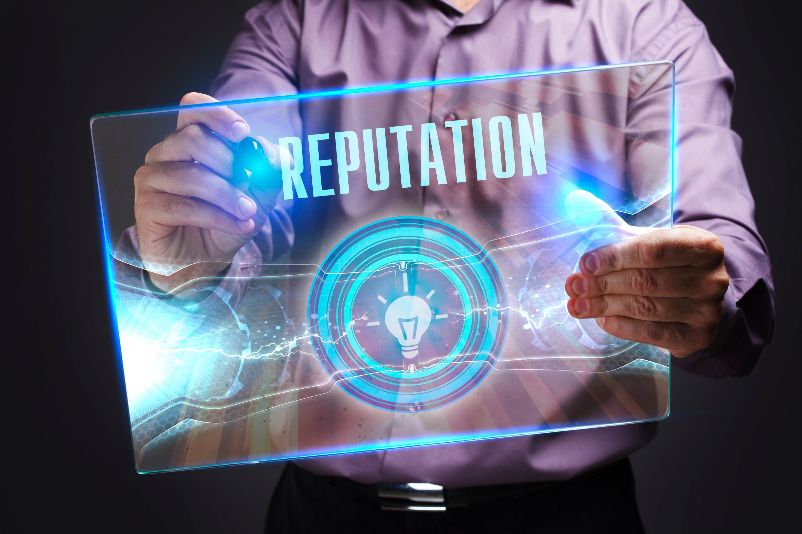 A man holding up a glass screen with the word reputation on it.