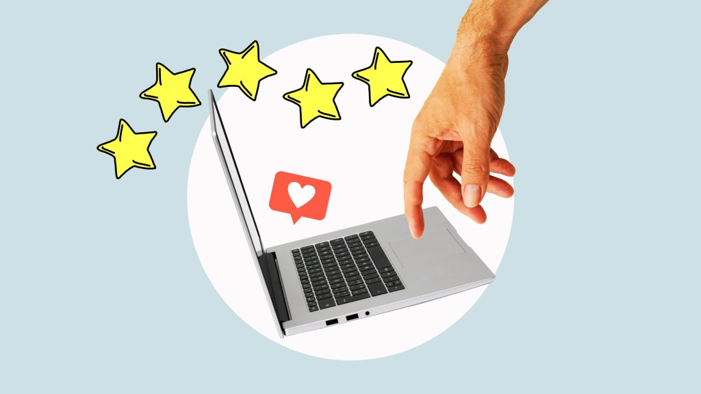 A hand is pointing to a laptop with stars on it.