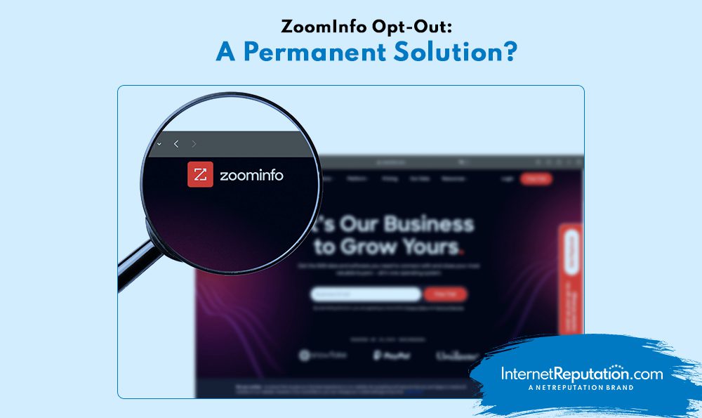 A magnifying glass focuses on the ZoomInfo Opt-Out logo on a webpage with the headline "ZoomInfo Opt-Out: A Permanent Solution?" against a dark, blurred background.