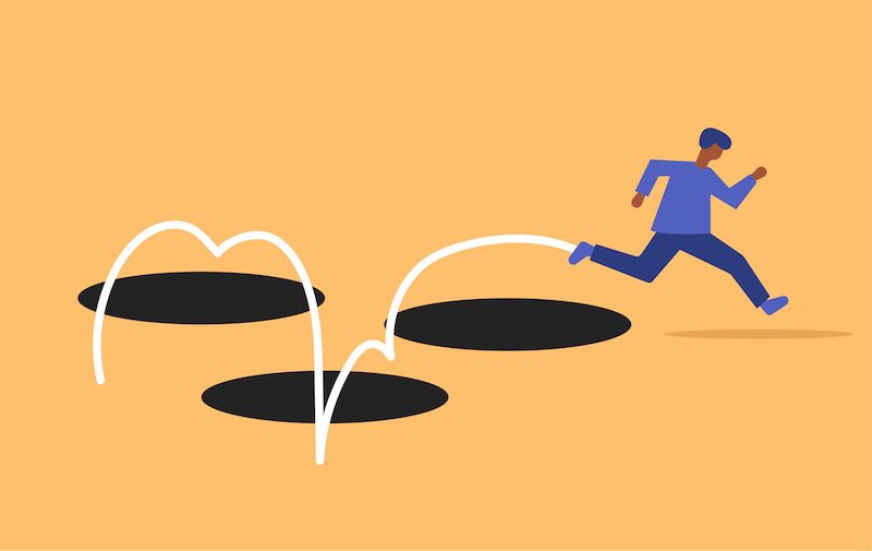 Illustration of a person running and leaping over several large holes in the ground.